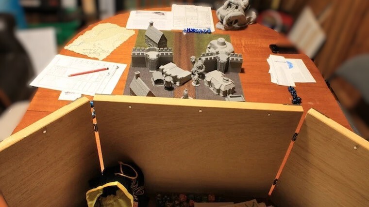 Unpainted 3D printed modular castle walls and houses arranged on a gaming table Unpainted 3D printed modular castle walls and houses arranged on a gaming table